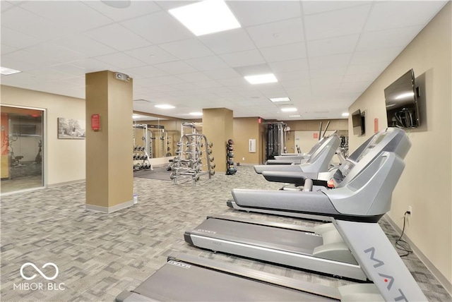 gym with light carpet and a drop ceiling