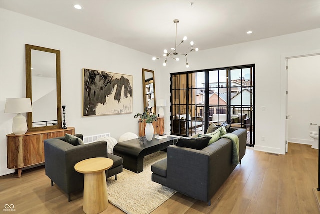 527 E N St, Indianapolis, IN 46204 - living area with a chandelier, wood finished floors, recessed lighting, and baseboards
