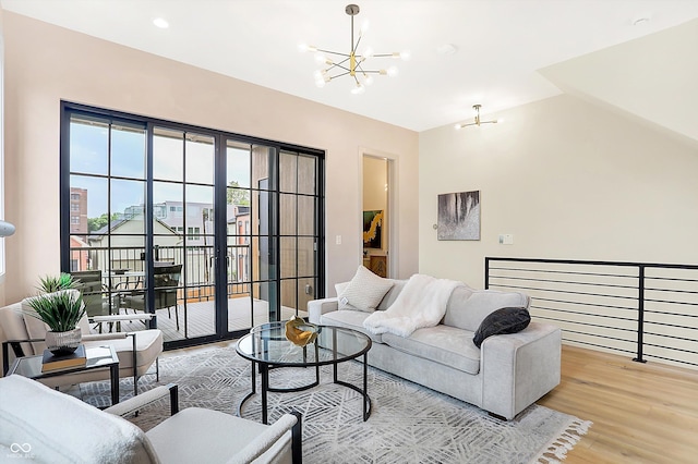 living room with a chandelier and light wood-type flooring