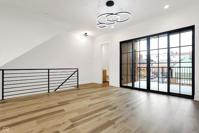 interior space with light wood-type flooring and a chandelier