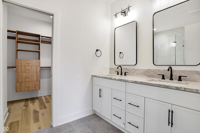 bathroom featuring hardwood / wood-style floors, vanity, and an enclosed shower