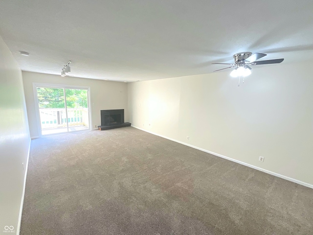 unfurnished living room featuring carpet and ceiling fan