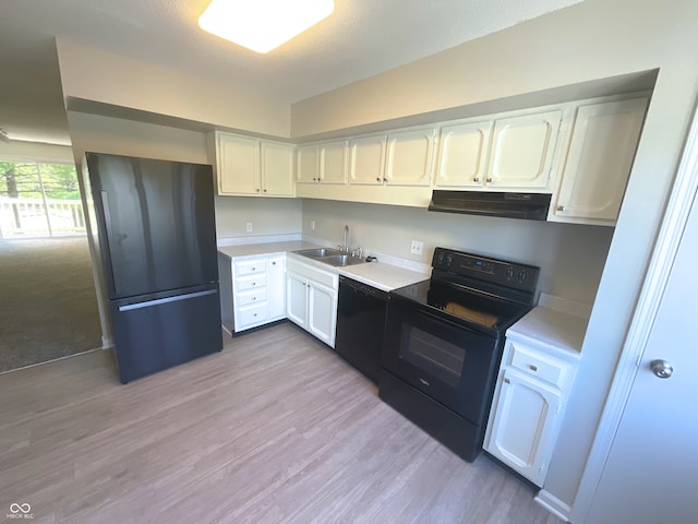 kitchen with sink, black appliances, light hardwood / wood-style flooring, white cabinets, and range hood