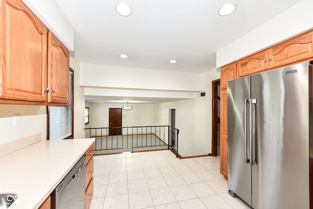 kitchen with light tile patterned flooring, a chandelier, and appliances with stainless steel finishes