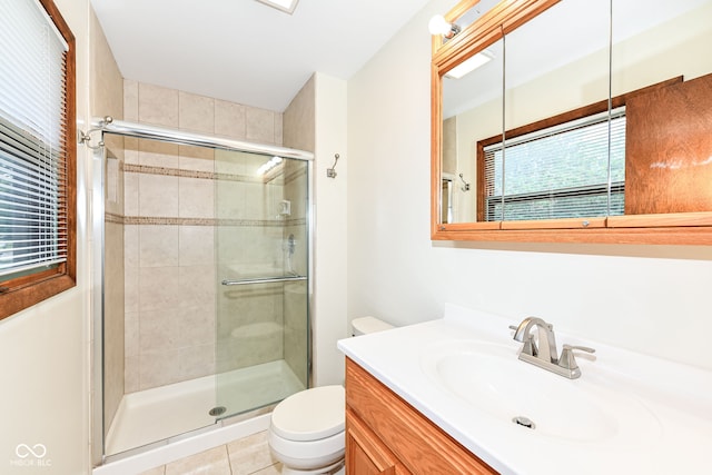 bathroom with toilet, an enclosed shower, tile patterned floors, and vanity