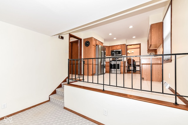 stairway featuring carpet flooring