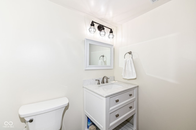 bathroom featuring toilet and vanity