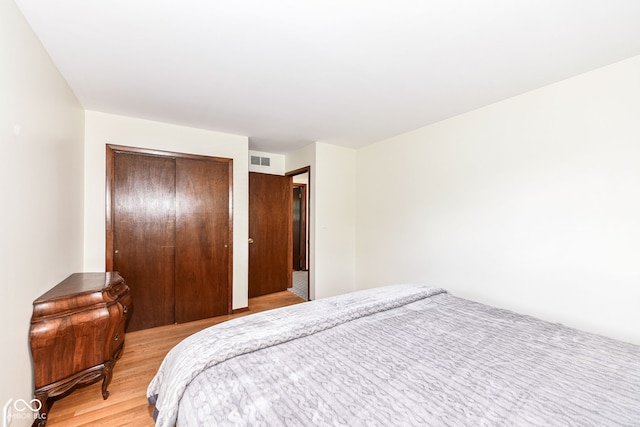 bedroom with a closet and light hardwood / wood-style floors