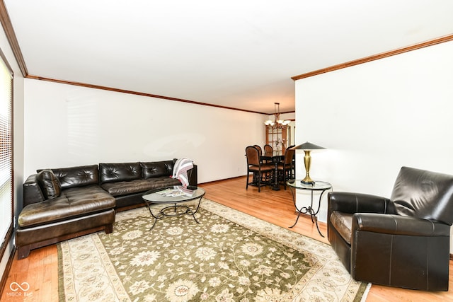 living room featuring a chandelier, hardwood / wood-style floors, and ornamental molding