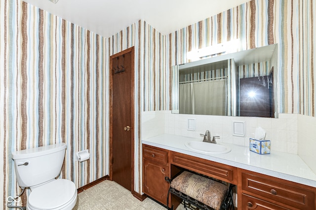 bathroom with toilet and vanity