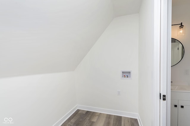 washroom featuring dark wood-type flooring and washer hookup