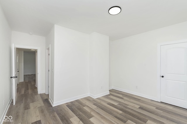 spare room with wood-type flooring