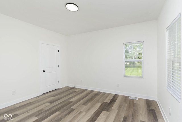 empty room featuring wood-type flooring