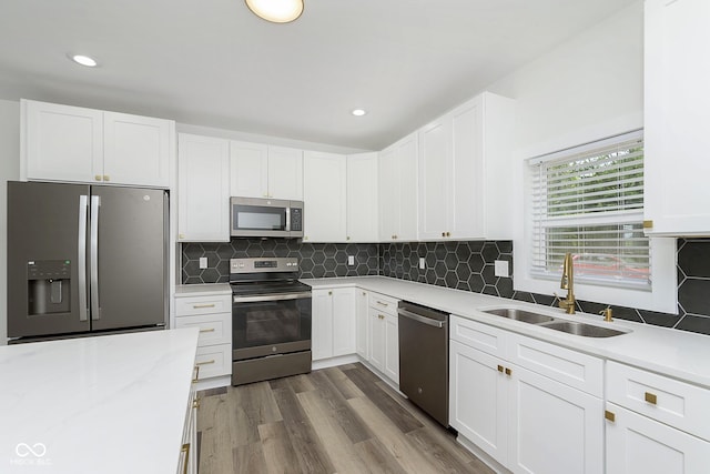 kitchen featuring sink, white cabinets, and appliances with stainless steel finishes