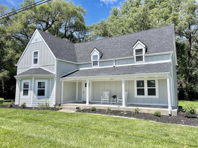 view of front of home featuring covered porch and a front lawn