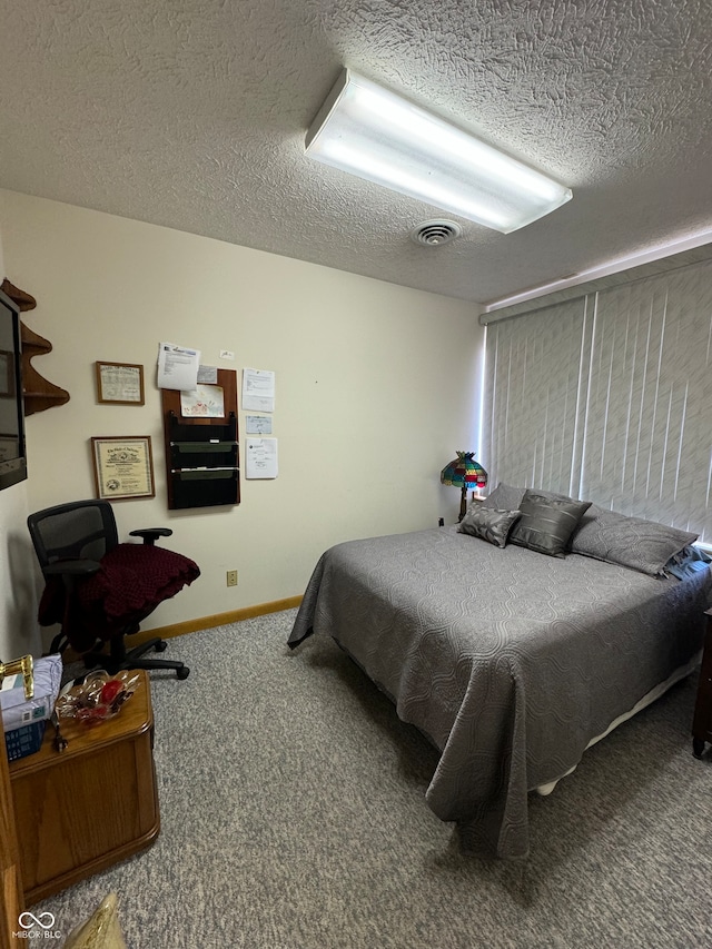 carpeted bedroom with a textured ceiling