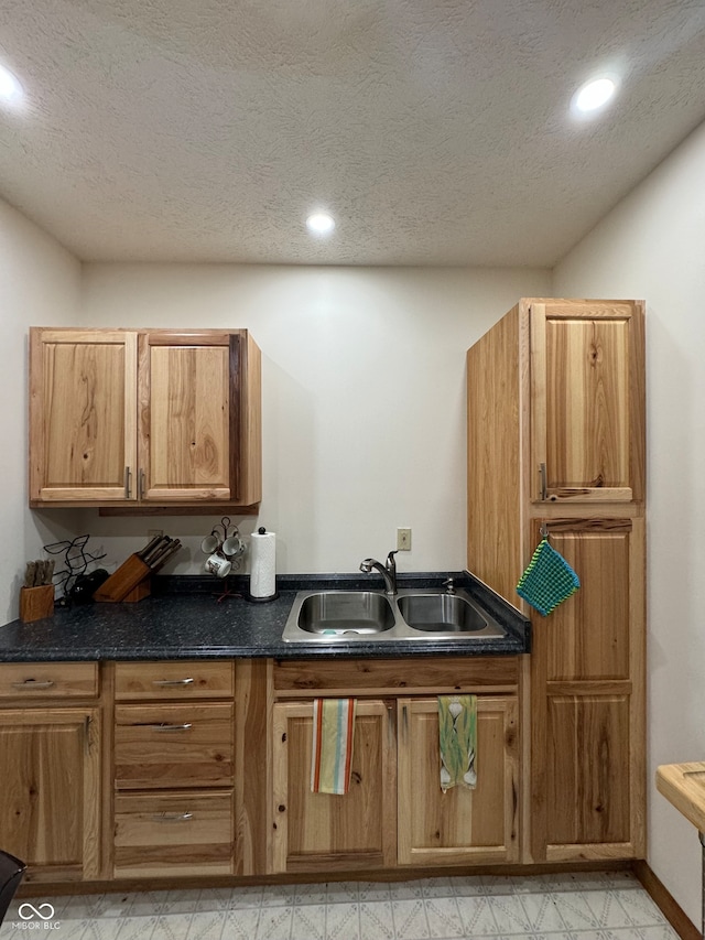 kitchen with sink and a textured ceiling