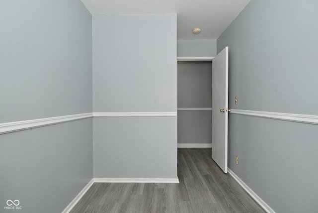 unfurnished room with dark hardwood / wood-style flooring