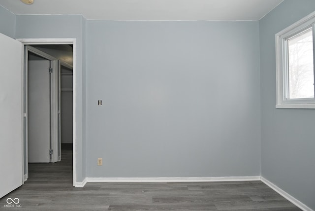 empty room with dark hardwood / wood-style flooring