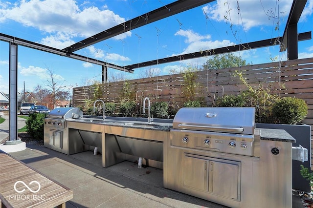 view of patio featuring sink, area for grilling, and exterior kitchen