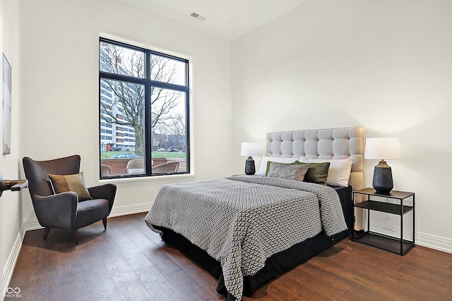 bedroom with dark hardwood / wood-style floors