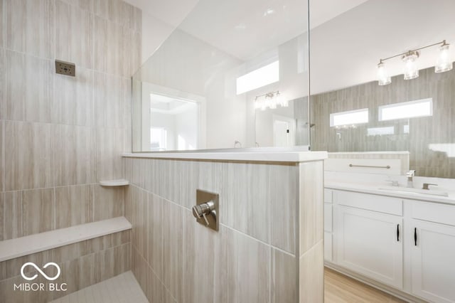 bathroom featuring vanity and tiled shower