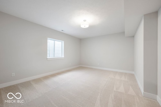 spare room with light colored carpet