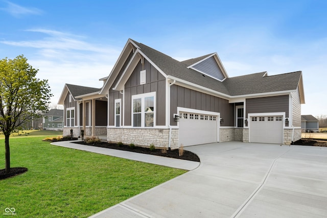 craftsman-style house with board and batten siding, concrete driveway, a front yard, a shingled roof, and a garage