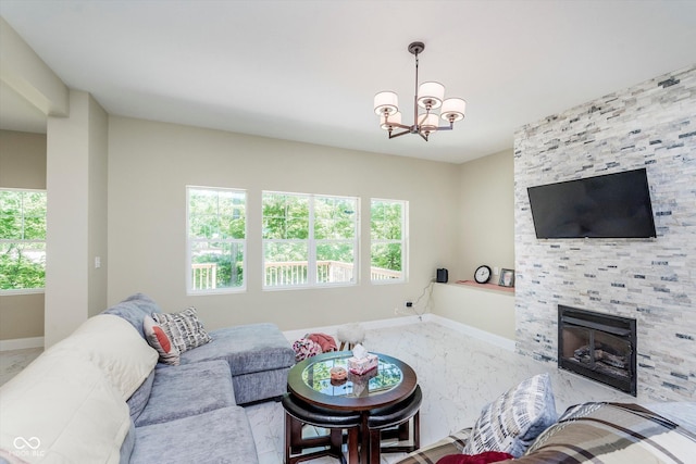 living room with a chandelier and a tiled fireplace