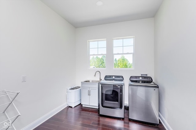 laundry room featuring cabinets, separate washer and dryer, and sink