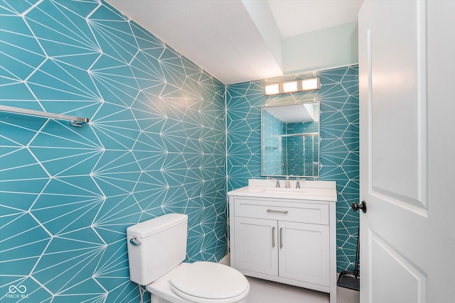 bathroom featuring walk in shower, tile patterned floors, vanity, and toilet