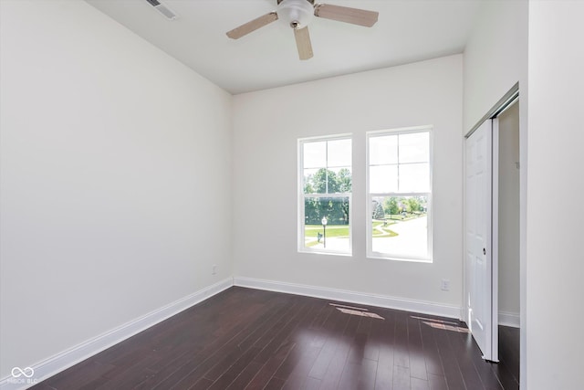 unfurnished room with dark hardwood / wood-style floors and ceiling fan