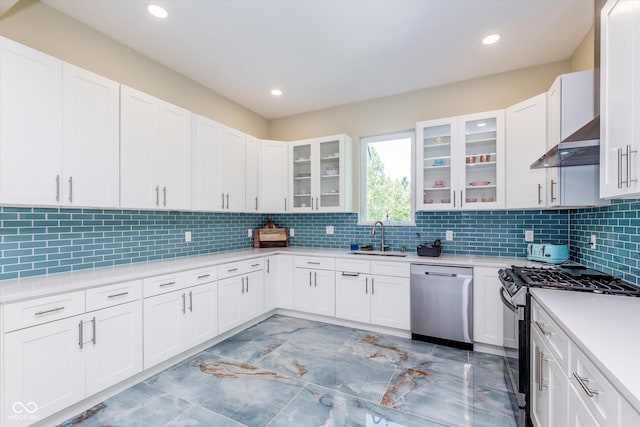 kitchen with white cabinetry, stainless steel appliances, sink, and backsplash