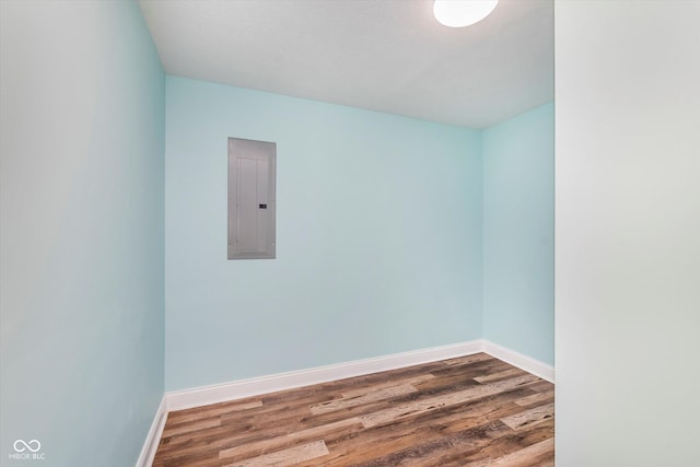 spare room featuring hardwood / wood-style flooring and electric panel