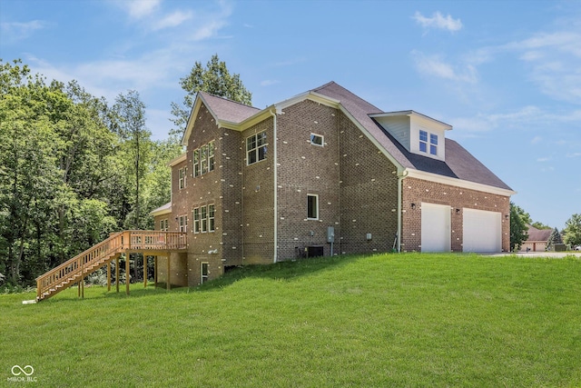 view of home's exterior featuring a wooden deck, a garage, central AC unit, and a lawn