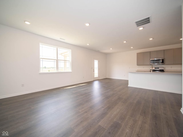 unfurnished living room featuring dark hardwood / wood-style floors