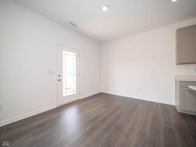 unfurnished living room featuring dark wood-type flooring