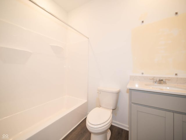 full bathroom with vanity, hardwood / wood-style floors,  shower combination, and toilet