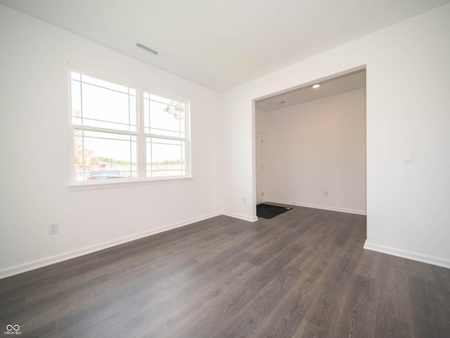 spare room featuring dark hardwood / wood-style floors