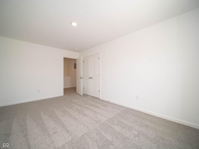 unfurnished room with light carpet