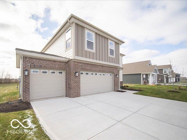 view of front of property with a garage and a front lawn