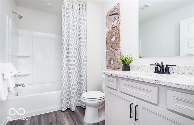 full bathroom featuring toilet, vanity, shower / tub combo with curtain, and hardwood / wood-style floors