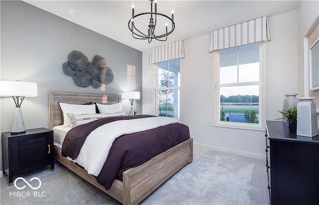 bedroom with light colored carpet and an inviting chandelier