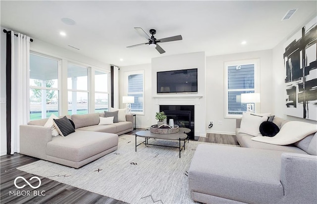 living room with hardwood / wood-style floors and ceiling fan