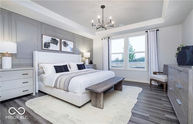 bedroom with dark hardwood / wood-style flooring, ornamental molding, and a notable chandelier