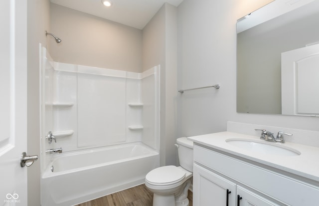 full bathroom with toilet, wood-type flooring, vanity, and bathing tub / shower combination