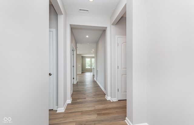 corridor featuring light hardwood / wood-style floors