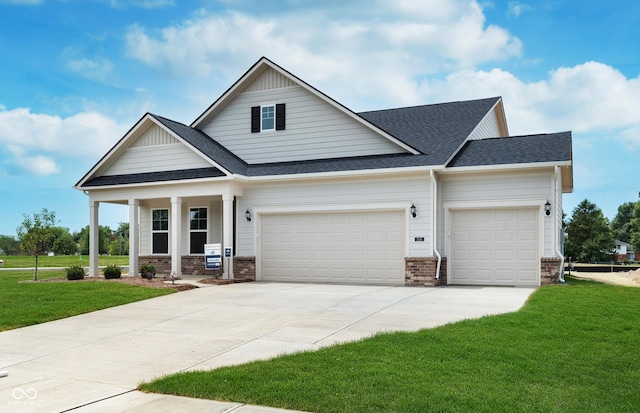 craftsman-style house with a front yard, a garage, and a porch