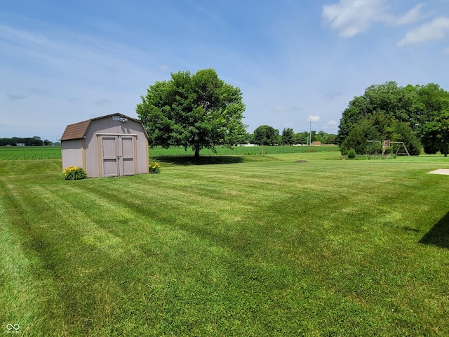 view of yard with a rural view and a storage unit