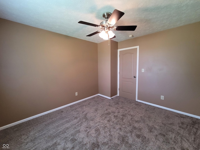 carpeted spare room featuring ceiling fan and a textured ceiling